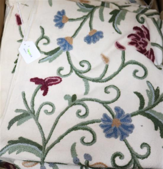 A crewel work double bedspread, embroidered with trailing flowers and foliage and a piece of matching fabric